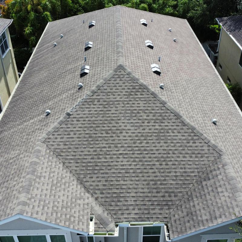 Shingle roof with multiple vents and ridge caps