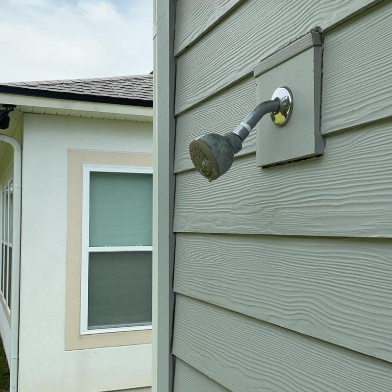 Outdoor showerhead with ball valve installation on siding Outdoor showerhead with ball valve installation on siding