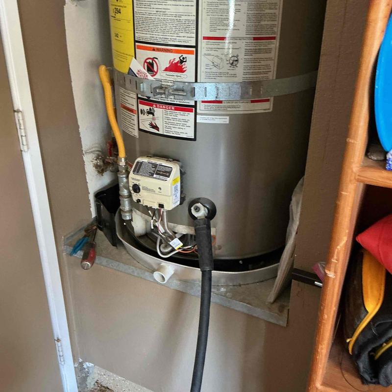 Water heater with hose connected for flushing