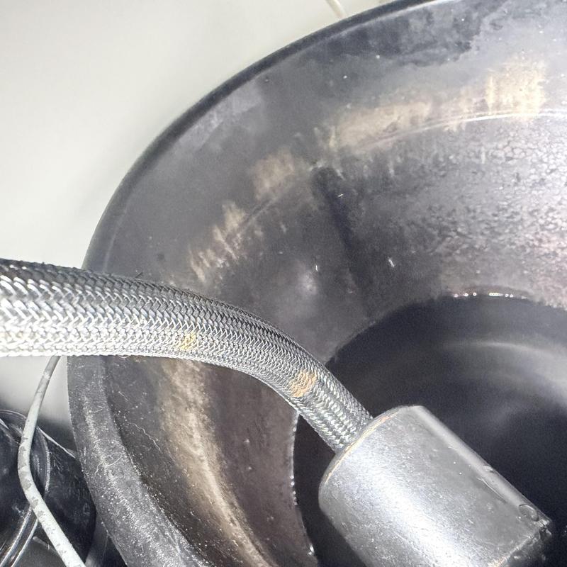 Braided water supply hose with leak under kitchen sink Braided water supply hose with leak under kitchen sink