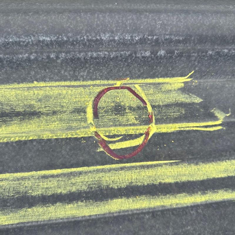 Metal roofing panel hail damage marked with yellow chalk