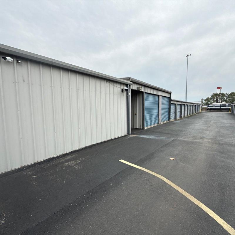 Metal storage unit exterior with blue roll-up doors