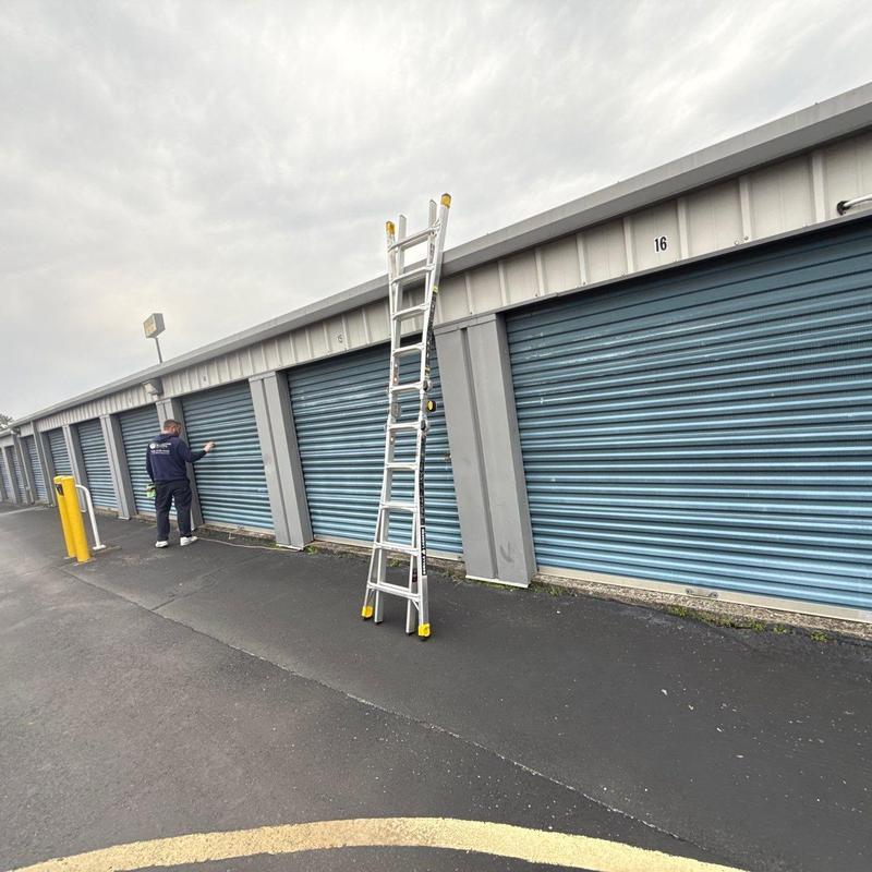 Storage unit roll-up doors with inspection ladder nearby