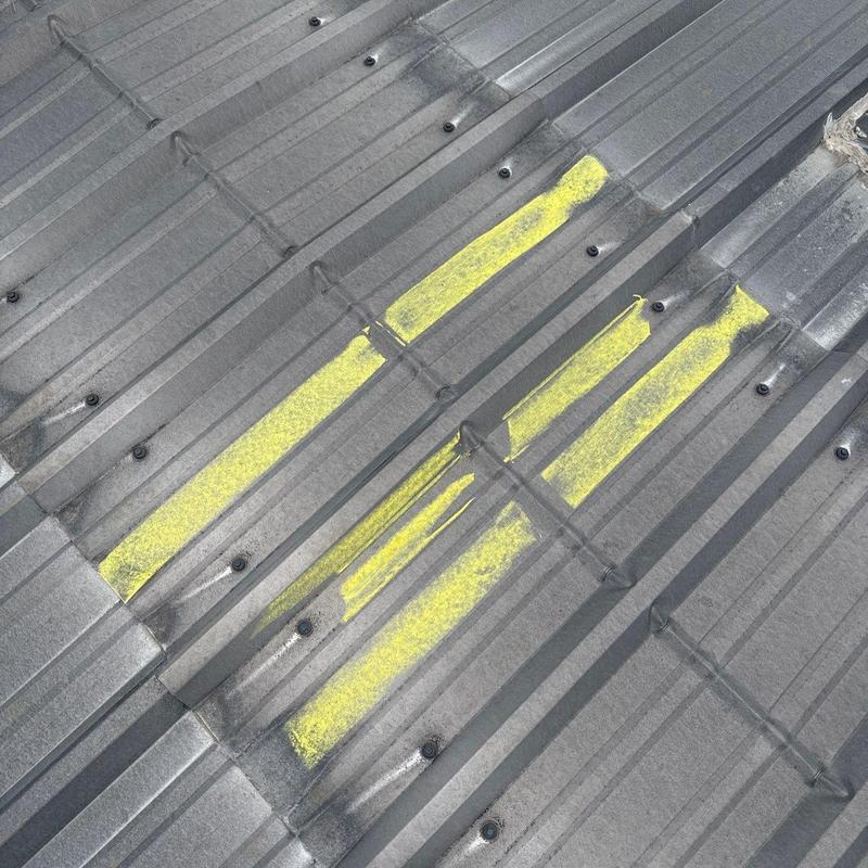 Metal roof panels with marked hail damage areas