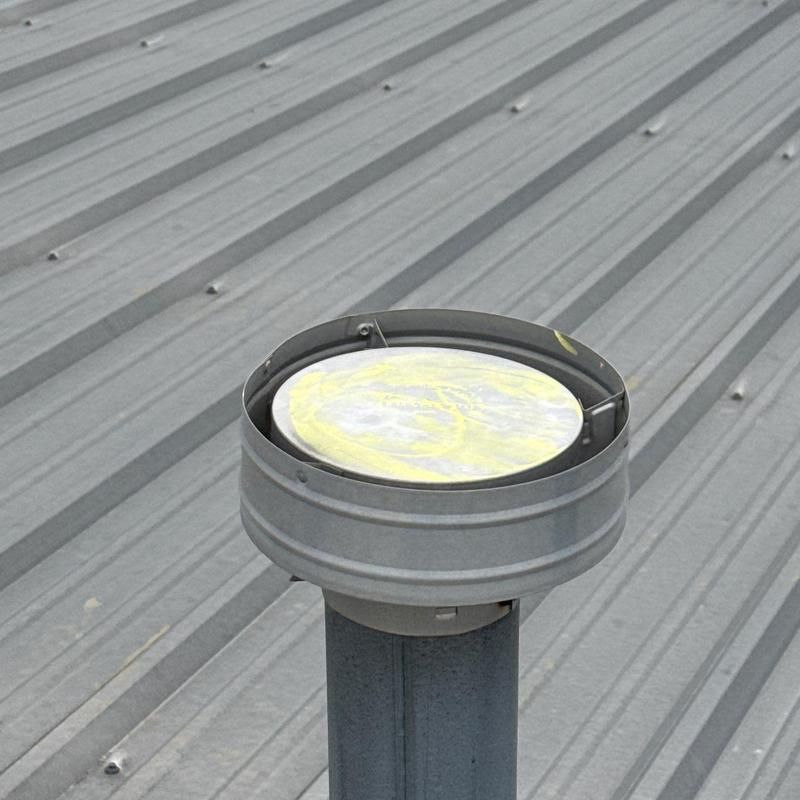 Metal pipe vent cap on corrugated metal roof