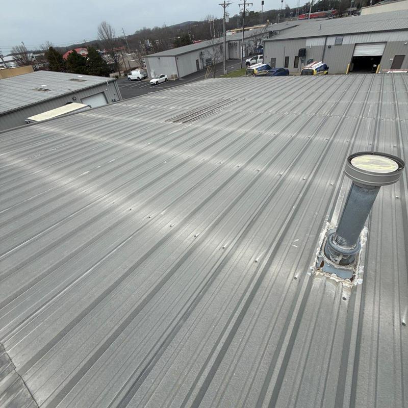 Metal roof with vent pipe flashing and hail damage