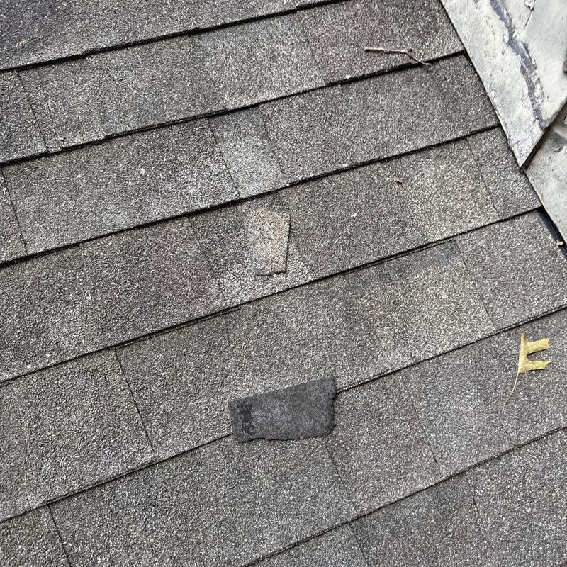 Asphalt roof shingles with hail damage and wear