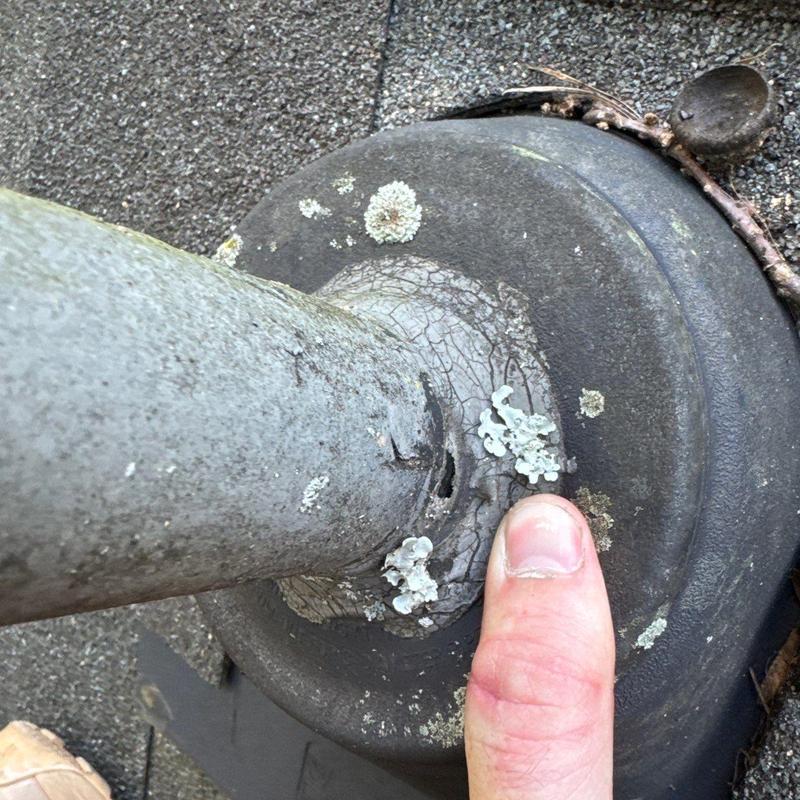 Roof flashing with cracked sealant and lichen growth