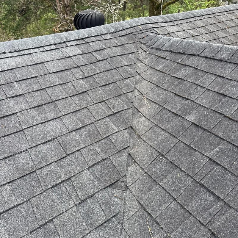 Asphalt shingle roof with hail damage on flashing