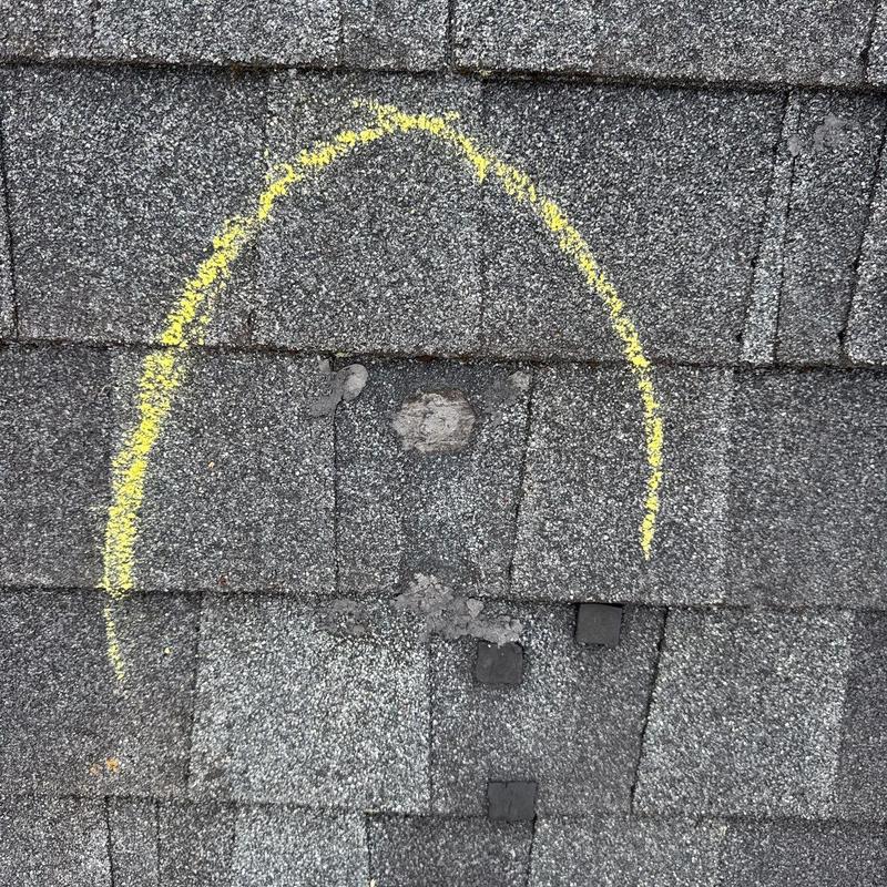 Roof shingle hail damage marked with yellow chalk