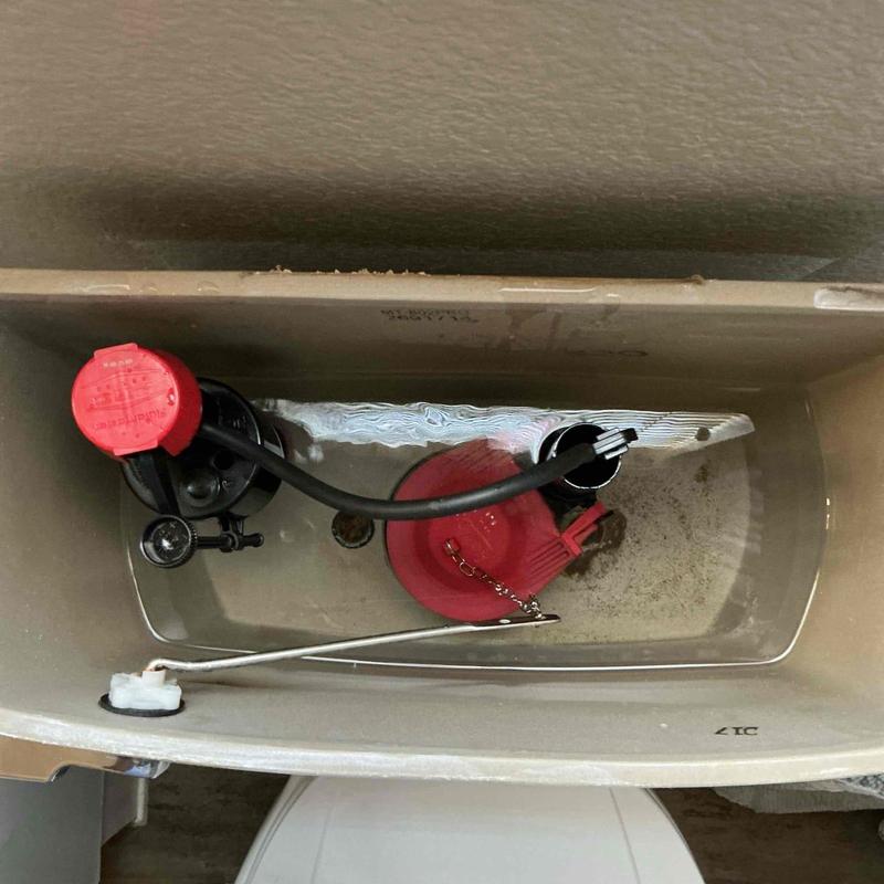Toilet fill valve and flapper assembly inside tank