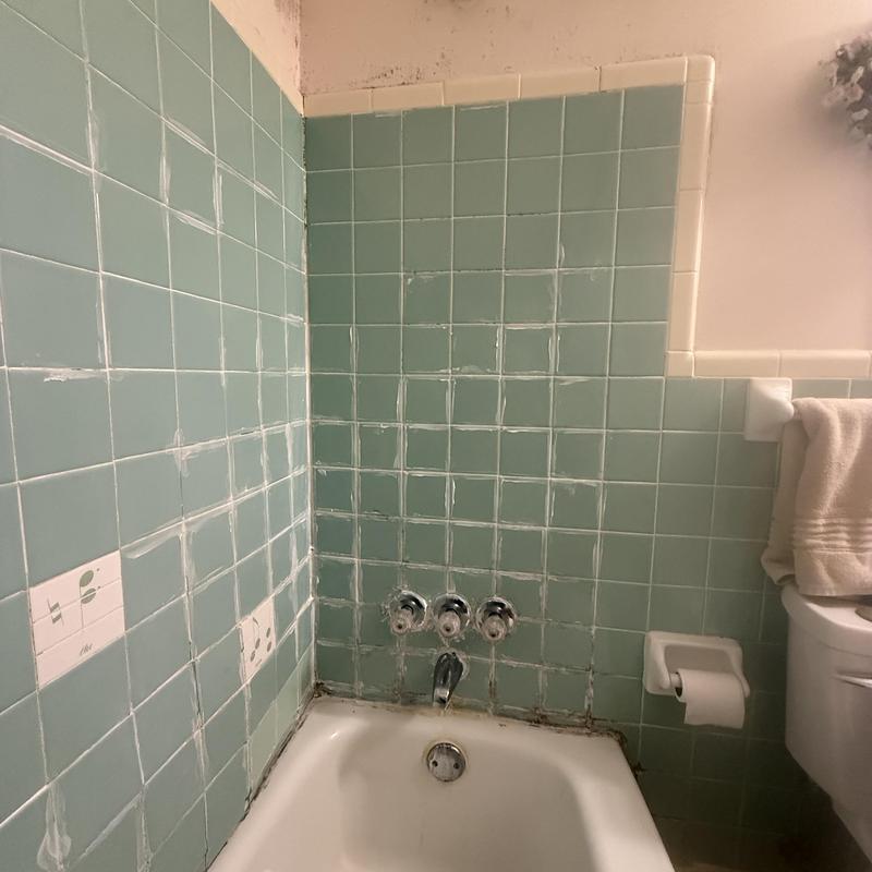 Shower valve and faucet in tiled bathtub surround