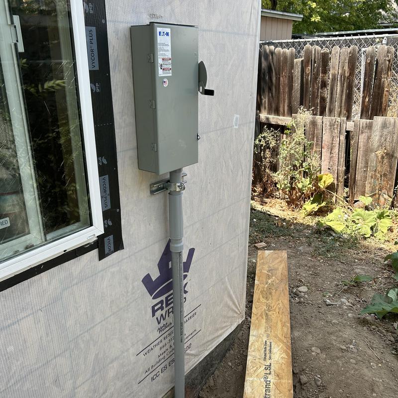 Electrical meter box and conduit installation on ADU wall