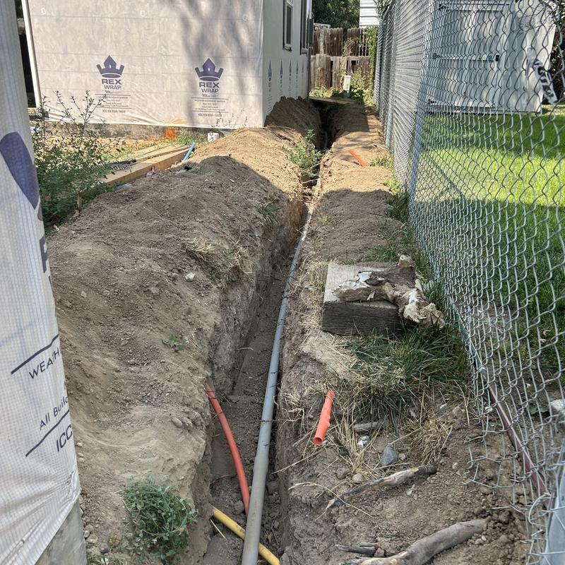Underground conduit installation for ADU wiring in trench