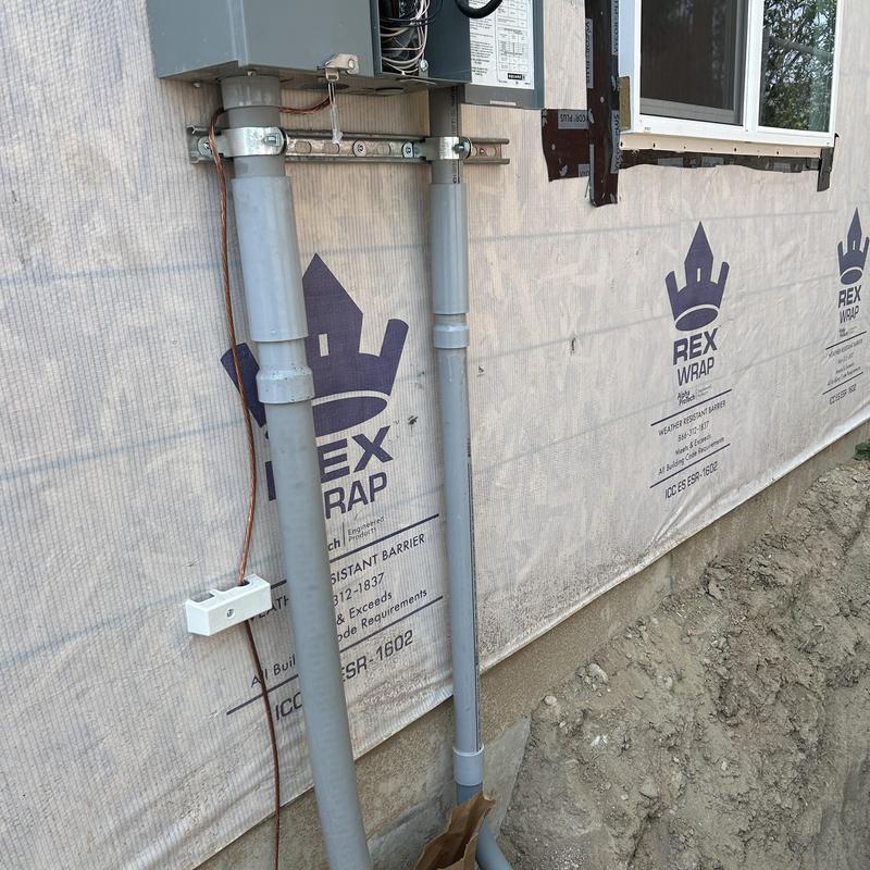 Underground electrical conduit installation at ADU exterior