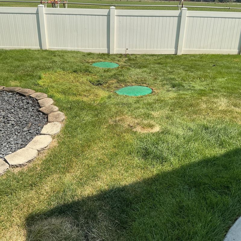 Septic system risers and lids installed in lawn Septic system risers and lids installed in lawn