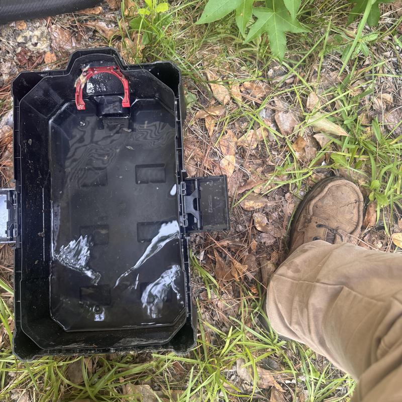 Heat pump drain pan with standing water outdoors