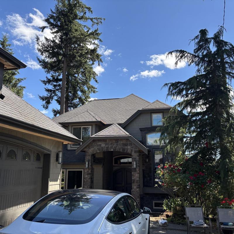 Asphalt shingle roof on residential home with garage Asphalt shingle roof on residential home with garage