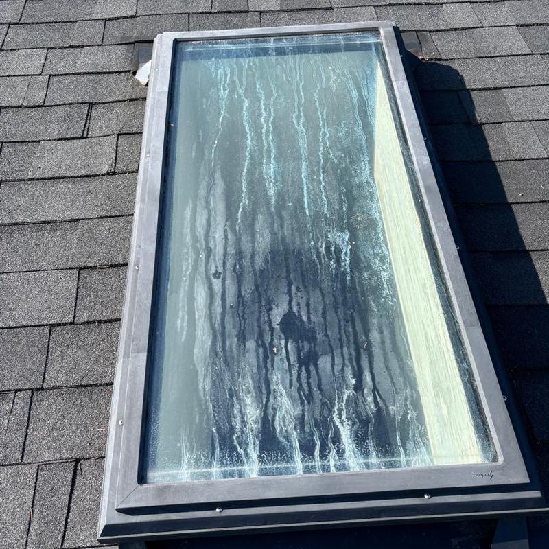 Skylight with water stains on roof shingles Skylight with water stains on roof shingles