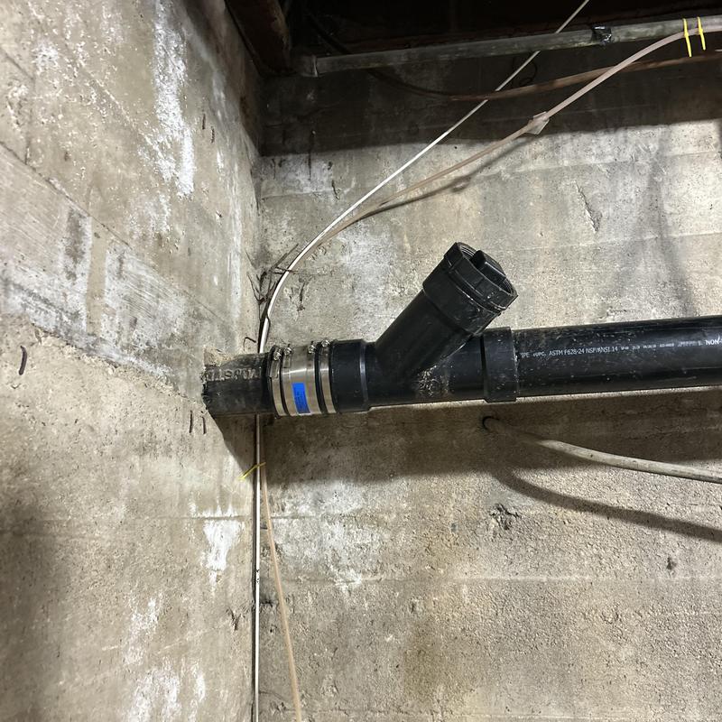 Cast iron mainline pipe with new PVC fitting and clamp Cast iron mainline pipe with new PVC fitting and clamp