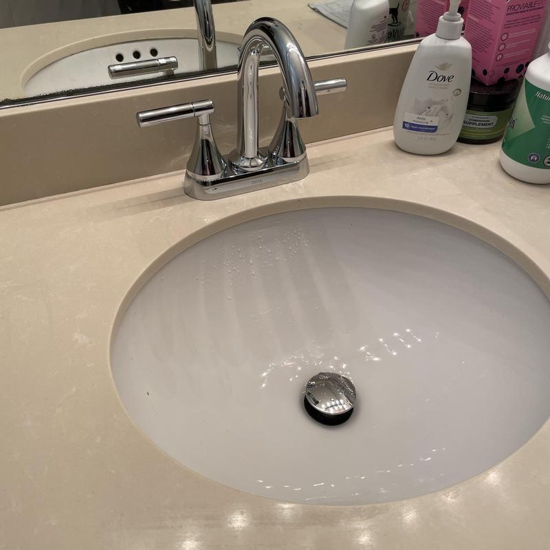 Bathroom faucet and pop-up drain assembly on sink
