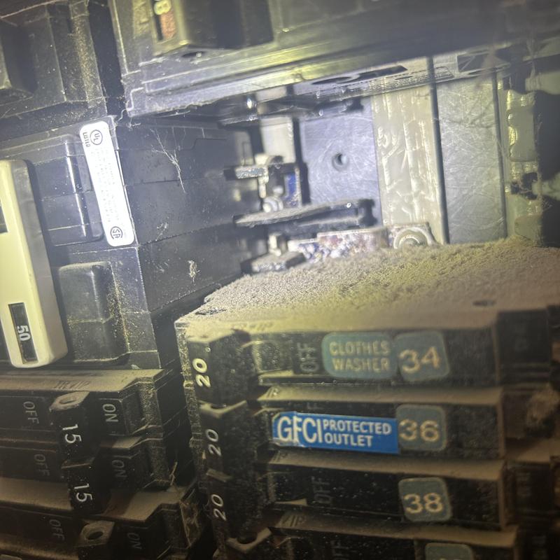 Main electrical panel with damaged busbar and breakers