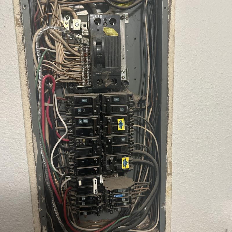 Electrical service panel with damaged bus bar and breakers