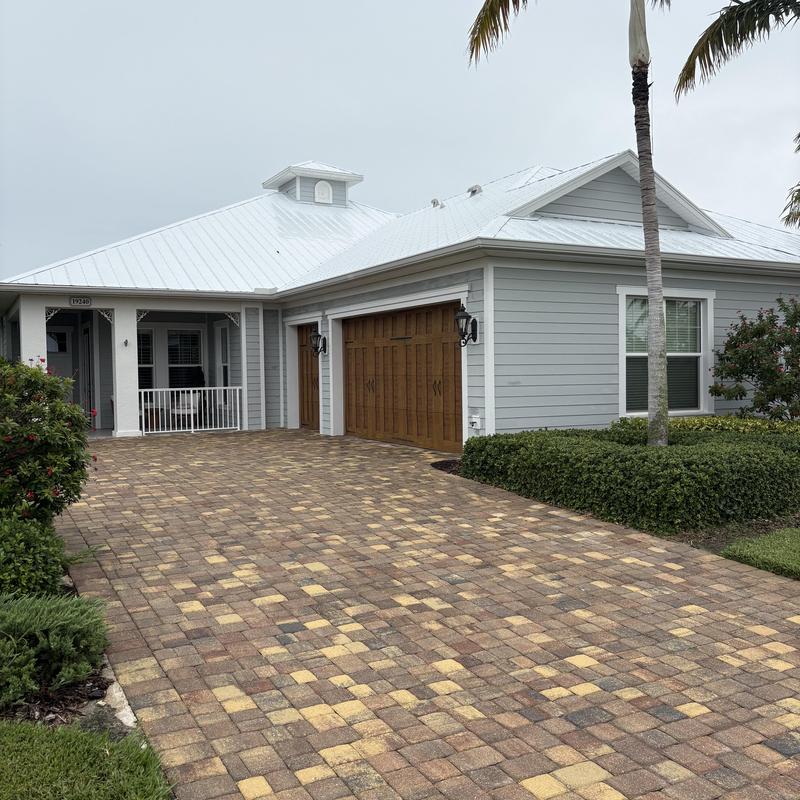 Paver driveway and garage doors at residential home