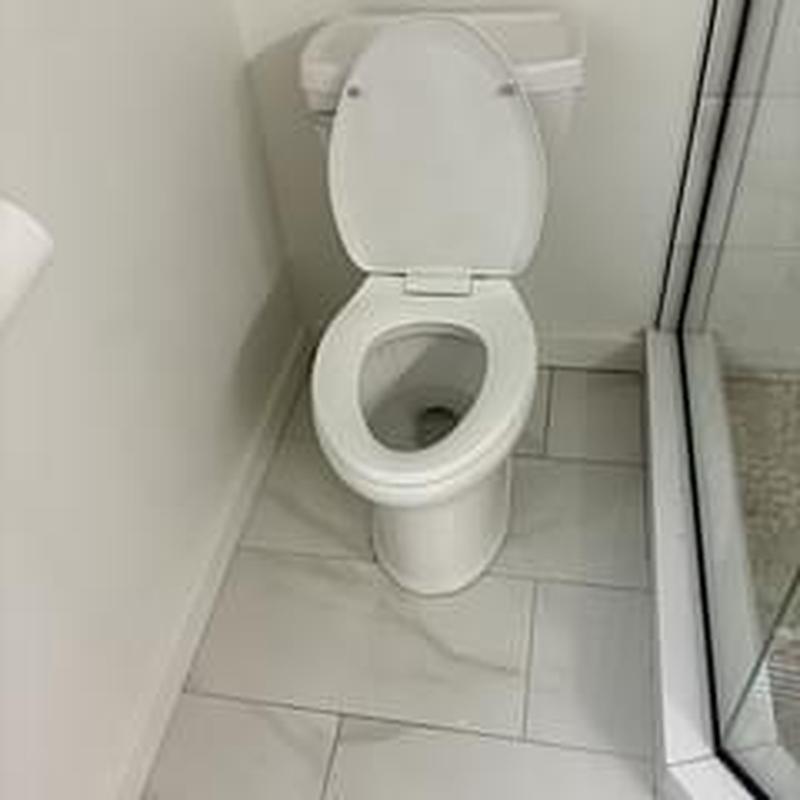 Toilet flange camera inspection in tiled bathroom corner