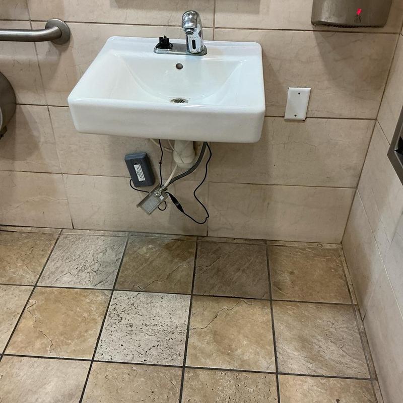 Sensor faucet with battery pack under sink in bathroom Sensor faucet with battery pack under sink in bathroom