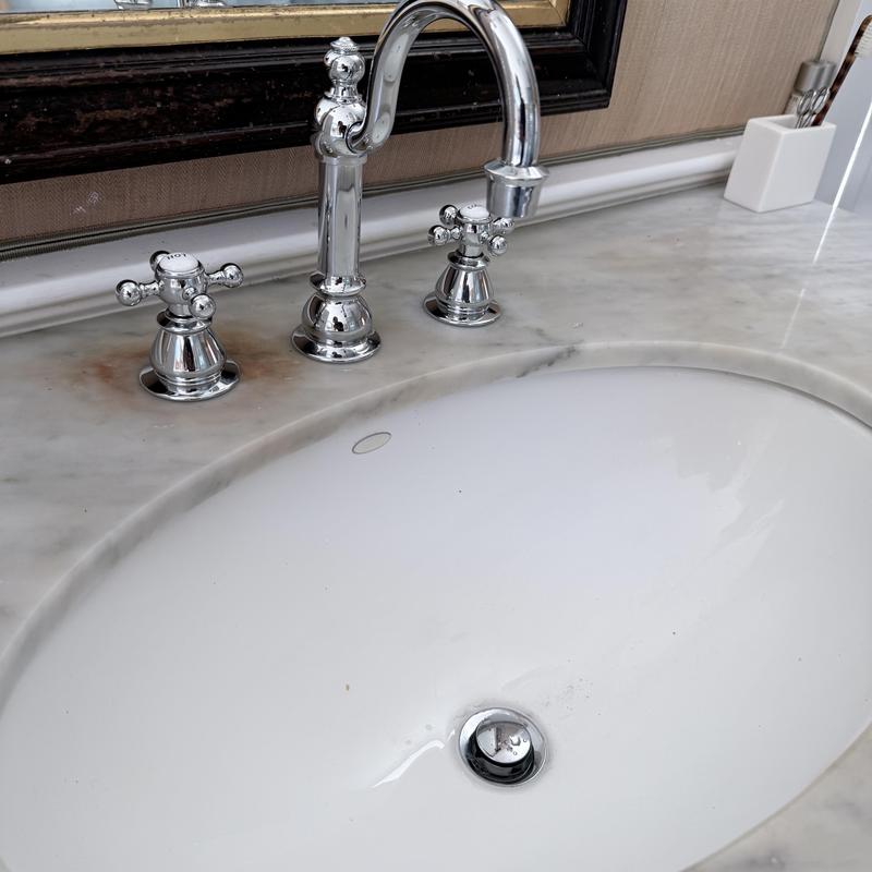 Chrome bathroom faucet with marble countertop and sink Chrome bathroom faucet with marble countertop and sink