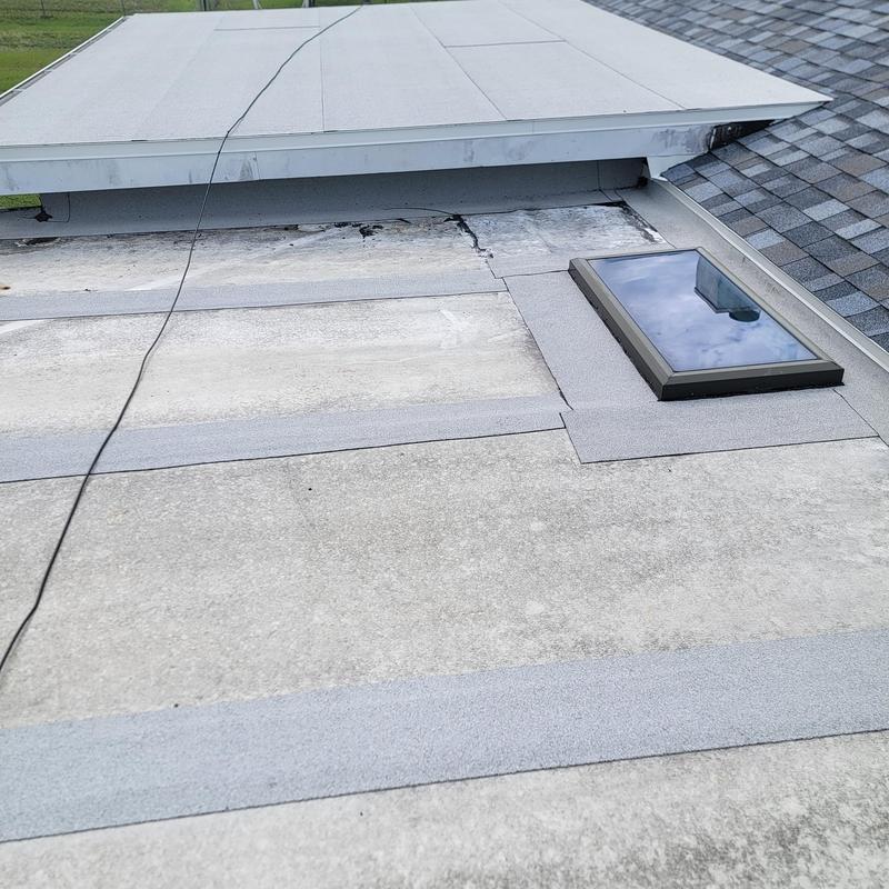 Flat roof patching near skylight and shingle roof edge Flat roof patching near skylight and shingle roof edge