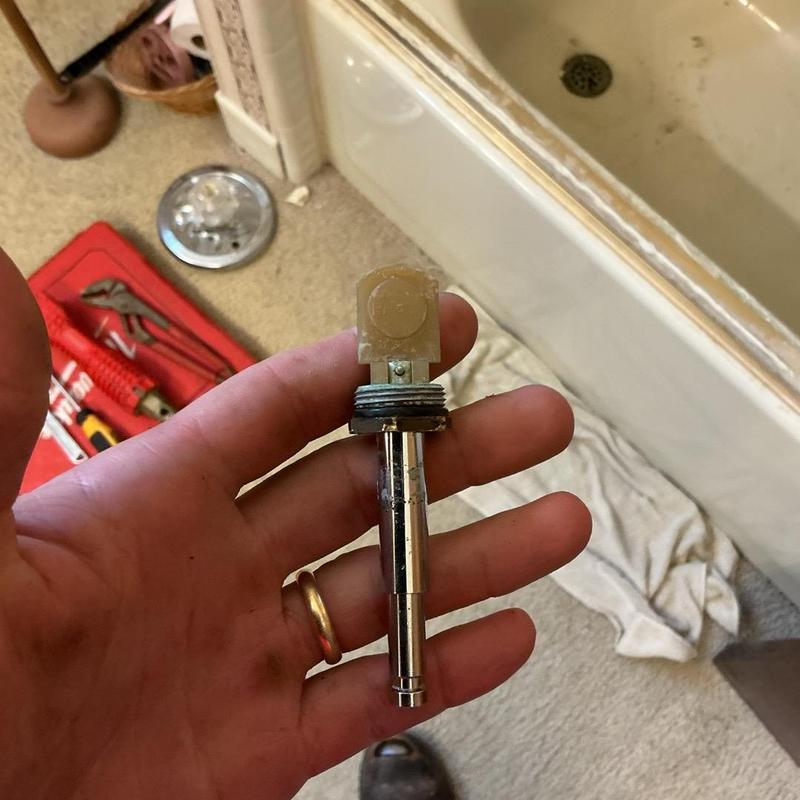 Moen Positemp shower valve cartridge held in hand Moen Positemp shower valve cartridge held in hand