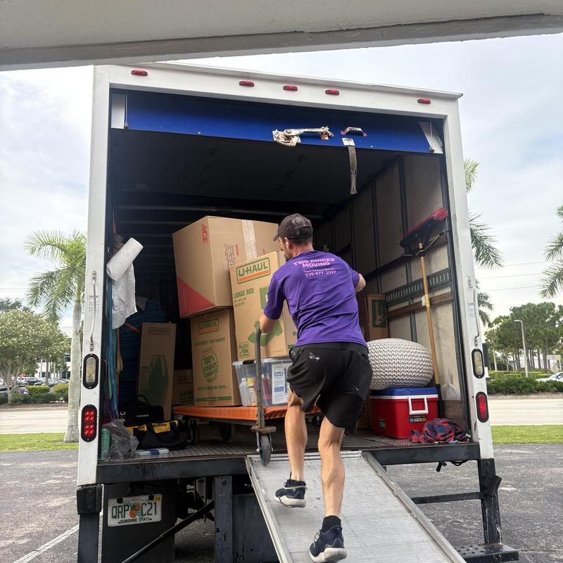 Moving truck loading U-Haul boxes and belongings