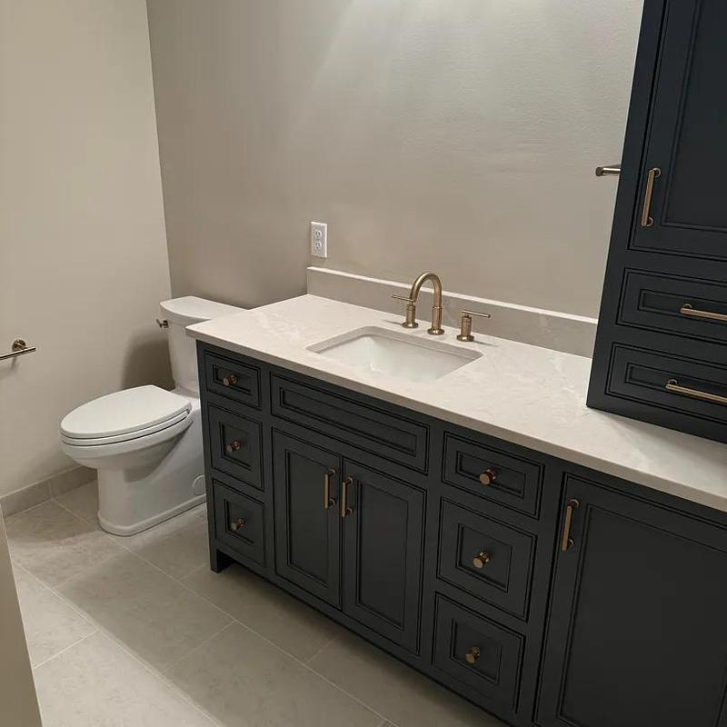 Bathroom vanity with sink and brass fixtures installed Bathroom vanity with sink and brass fixtures installed