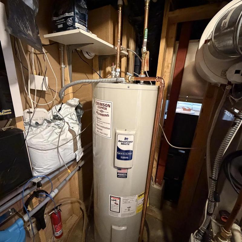 Electric water heater installation in basement utility room Electric water heater installation in basement utility room