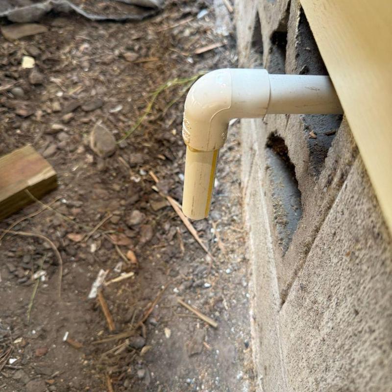 Water heater T&P relief valve piping outside wall
