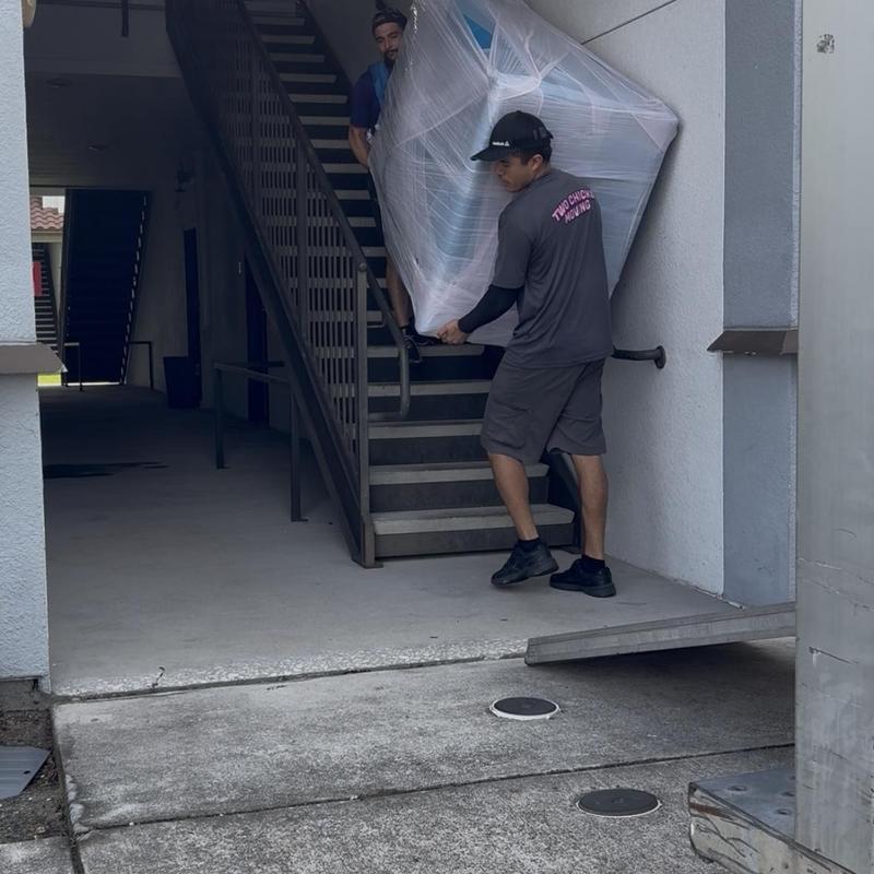 Sectional sofa wrapped and carried down stairs