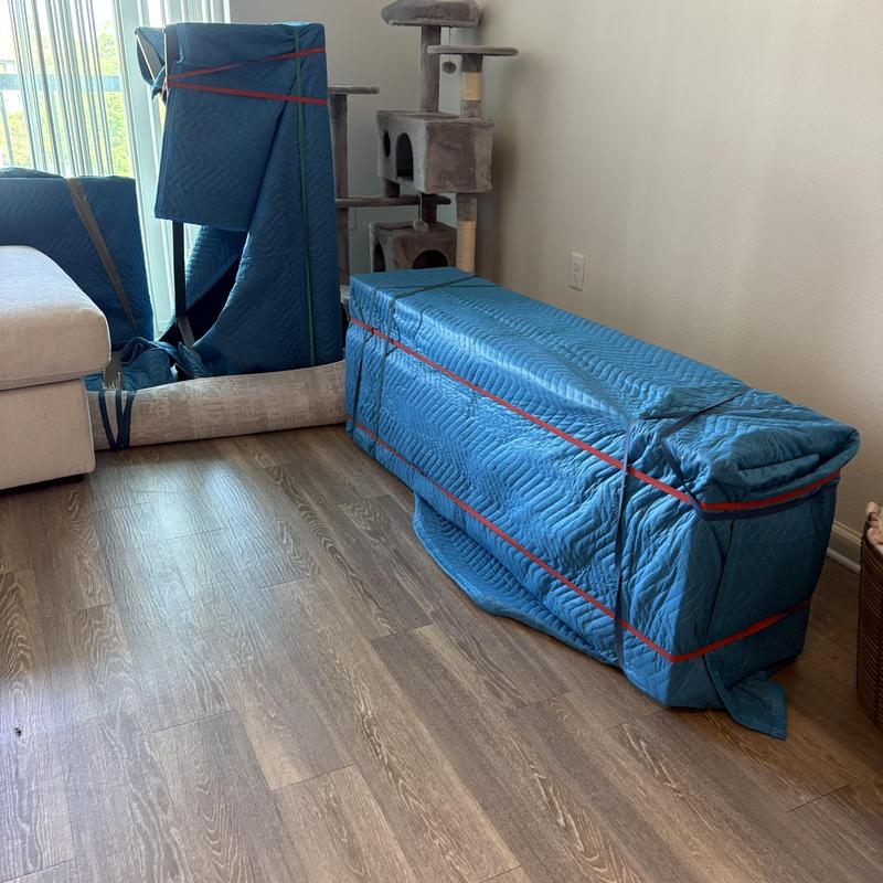 Sectional sofa wrapped and secured for moving