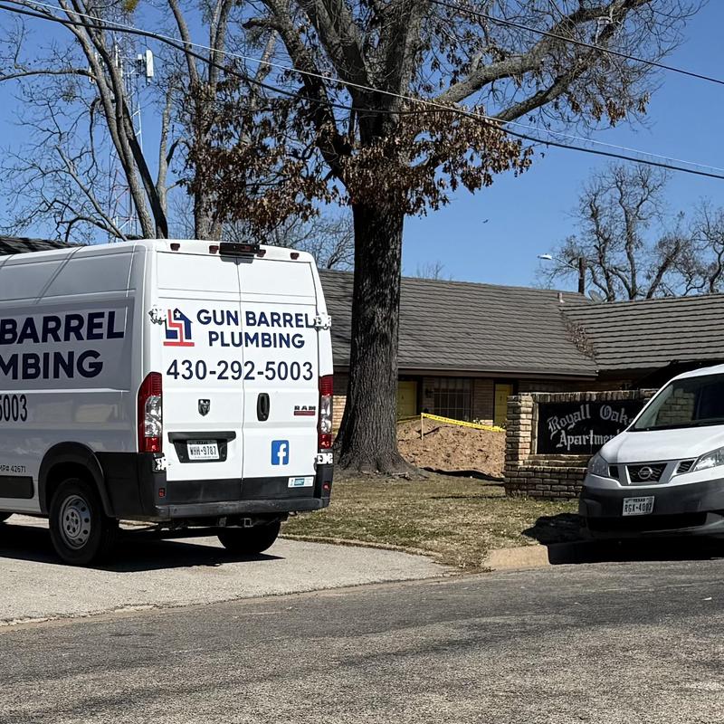 Clogged pipe plumbing service van outside apartment