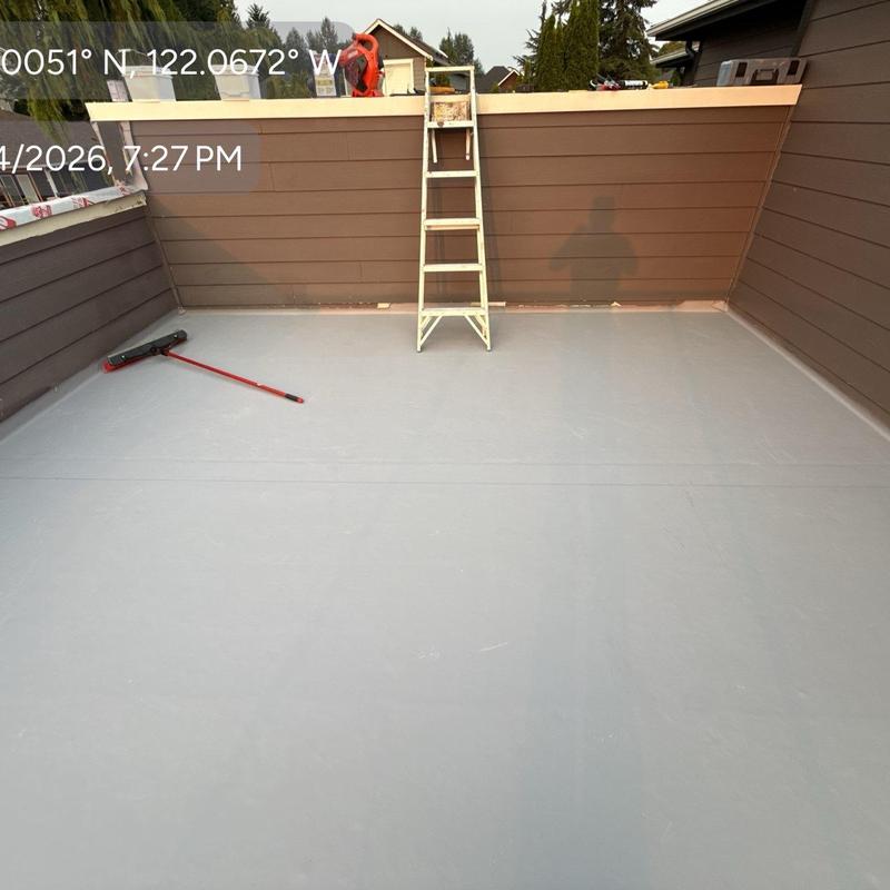 Flat roof membrane with ladder and broom on deck