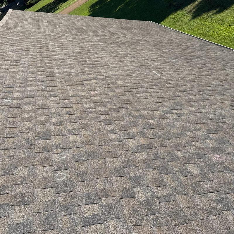 Asphalt shingles roof with hail damage markings