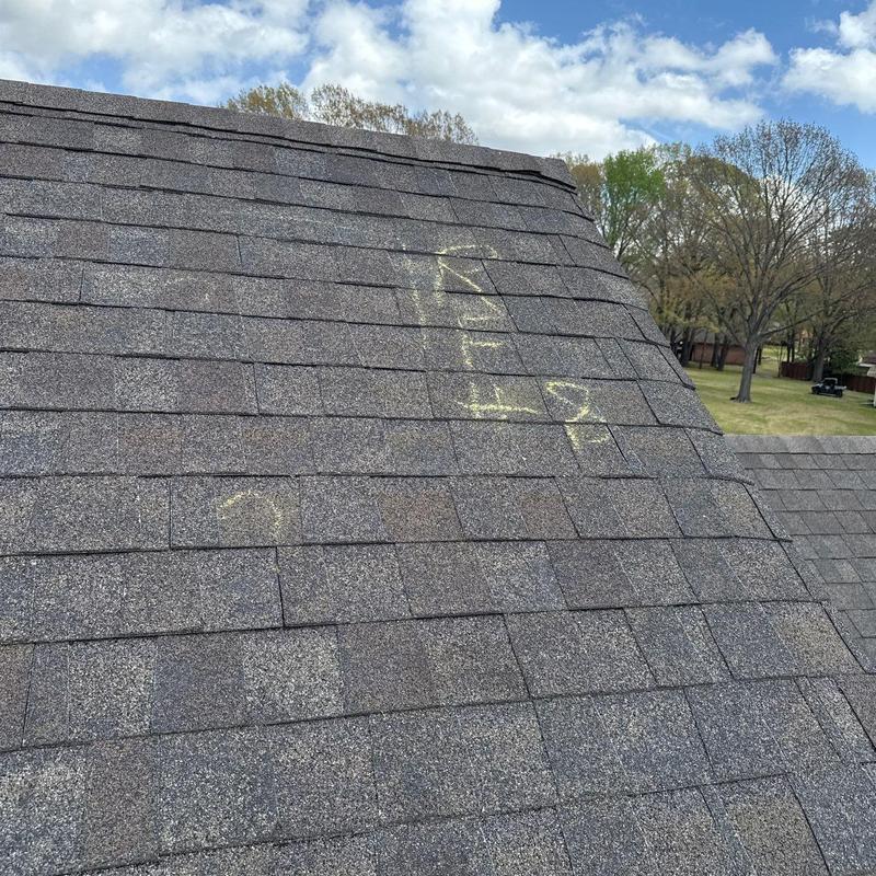 Asphalt roof shingles with hail damage markings