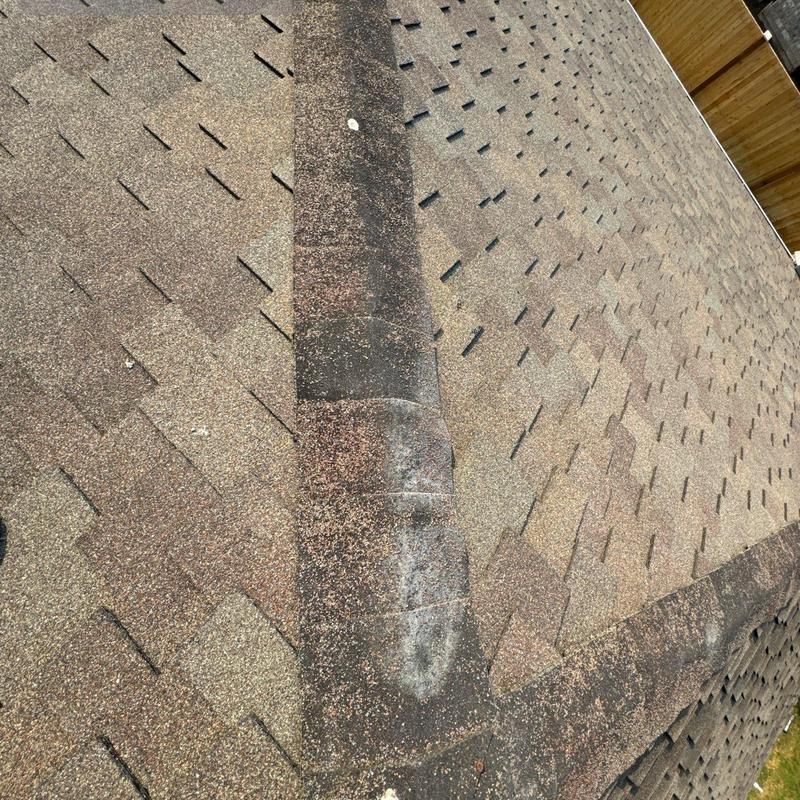 Damaged ridge cap on asphalt shingle roof