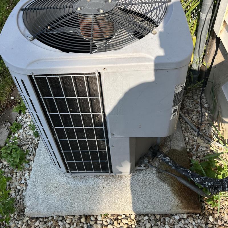 Outdoor air conditioning condenser unit on concrete pad Outdoor air conditioning condenser unit on concrete pad