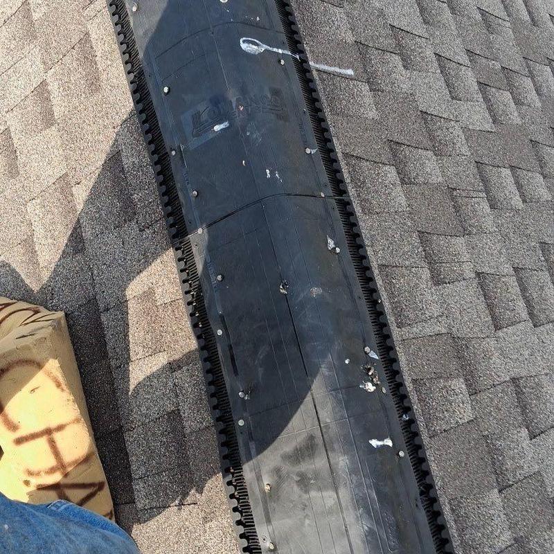 Roof ridge vent with hail damage on shingles