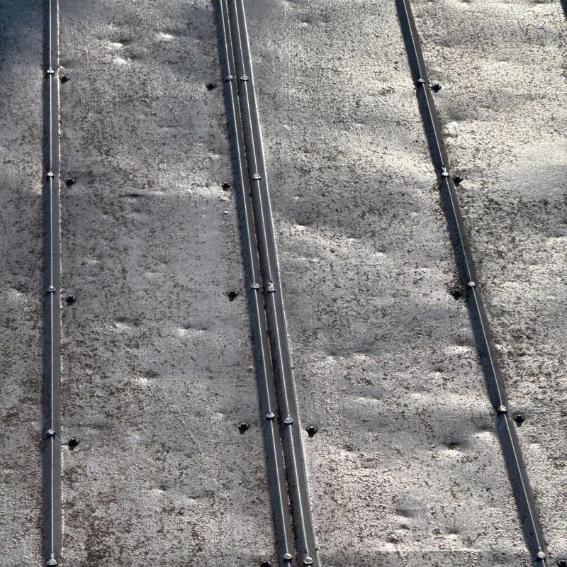 Metal roof panels with hail damage dents
