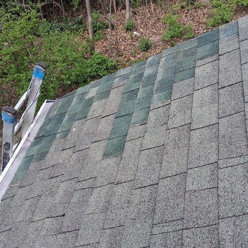 Asphalt shingles with storm damage on roof edge