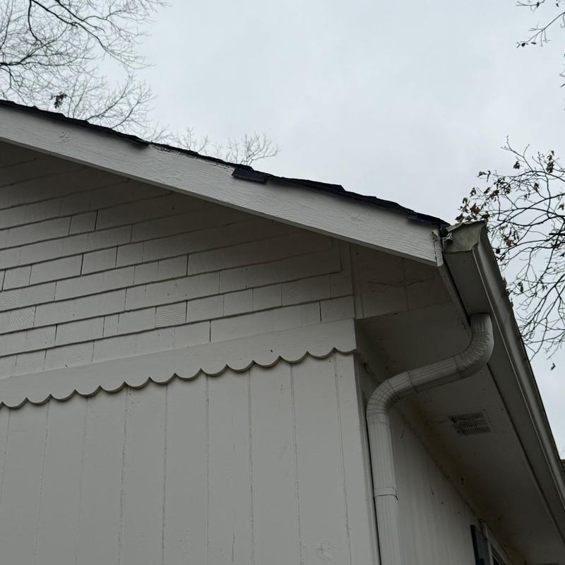 Roof shingles with visible hail damage on edge