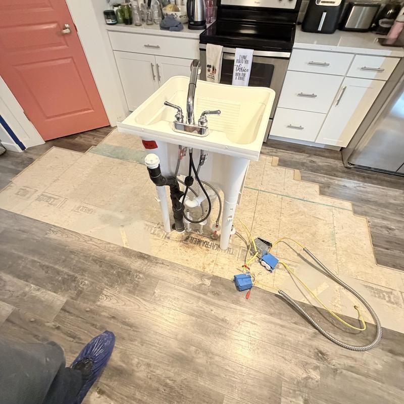 Laundry sink installation with plumbing connections
